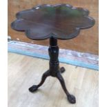A Victorian mahogany tilt top tripod table, the petal shaped top with a dished edge, raised on a