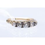 A five stone diamond ring comprising graduated old cut diamonds, total diamond weight approx. 0.
