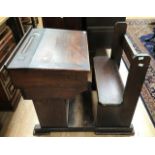 An early 20th Century childs pine desk with seat, along with a pink chest of drawers, early 20th