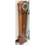 A 1930s oak eight day Grand Daughter clock, with three winder holes, Westminster chime, silvered