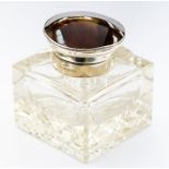 An Edwardian silver and tortoiseshell capped inkwell, having a cut glass body, Birmingham 1902 by