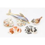 Royal Crown Derby paperweights comprising a dolphin with silver stopper, puppy with gold stopper,