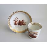 An English Porcelain Coffee Cup and Saucer. Painted in brown with a European landscape in Gilt