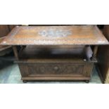 An early 20th Century oak monks bench, in the Renaissance Revival style, carved throughout, 80cm