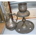 A Near Eastern tinned copper ewer, late 19th/early 20th Century, of pear form and incised with