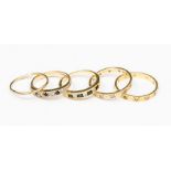 A collection of gold rings to include two 18ct gold stone set bands, one set with sapphire and