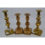 Two pairs of 19th Century brass candlesticks, with knopped baluster stems on rectangular feet,