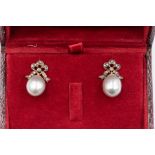 A pair of silver pearl and diamond stud earrings, the oval pearls approx. 11x  8mm suspended from