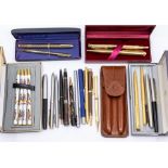 An assembled group of vintage and recent fountain pens, ballpoint pens and retracting pencils,
