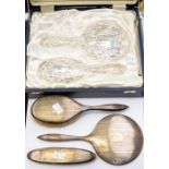 A Victorian style silver dressing table hair brush set, embossed decoration, cased together with