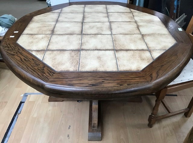 A late 20th Century oak dining table, with tiled top, together with a set of six oak ladder back