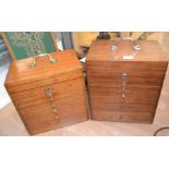 Two mid 20th Century desktop watchmaker's cabinets, one in teak, the other walnut, each with a swing