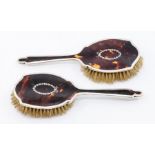 A pair of Edwardian silver mounted inlaid tortoiseshell dressing table brushes, the silver by Robert