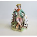A Staffordshire Figure of a Hunter and his Dog seated by his side Date: circa 1860  Size: 16cm