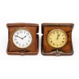 Two Asprey snakeskin cased travel clocks, the eight day 'pocket watch' movements in square tan