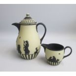 A Wedgwood  Black on Cane Jasper Coffee Pot and Cream Jug. Depicting a design based on a theme of ‘