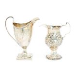A George III silver helmet shaped cream jug, bright-cut engraved squiggle work bands above