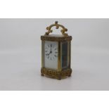 A French gilt brass carriage clock, early 20th Century, the serpentine five-glass case with