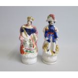 A pair of Staffordshire seated figures of Queen Victoria and Prince Albert.  Each with a lion and