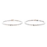 A pair of diamond set 18ct white gold bangles, comprising claw set alternate baguette cut and