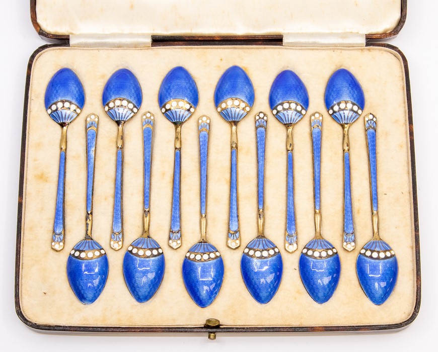 A set of twelve George VI silver gilt and enamel coffee spoons, the reverse with blue guilloche