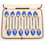A set of twelve George VI silver gilt and enamel coffee spoons, the reverse with blue guilloche
