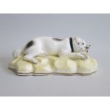 A Samuel Alcock model of a Mastiff, recumbent on a yellow ground rocky base. Date: circa 1840-50