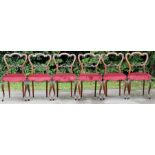 A set of six early Victorian rosewood balloon back chairs, circa 1860, having shaped backs, red