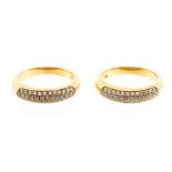 Two diamond and 18ct gold rings, each comprising a domed band pave set with three rows of round