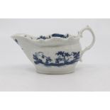 A Worcester sauce boat, circa 1770, relief moulded and with a scroll handle, painted in blue with