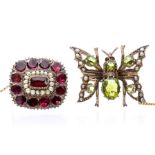 A Georgian flat cut garnet and pearl set brooch, the central rectangular garnet set within a