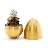 Stuart Devlin- a silver gilt surprise egg, textured form to reveal 'Humpty Dumpty' London 1976, size