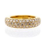 A diamond and 18ct gold ring, comprising a domed band pave set with three rows of round brilliant