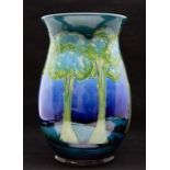 A Moorcroft Moonlit Blue vase, circa 1935-40, of ovoid shape and decorated with stylised trees in