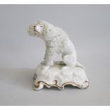 A Staffordshire ‘Lion Clipped’ Poodle seated on a scrolled base with gilt highlights. Probably