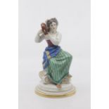 A Meissen figure of a rustic maid, late 19th/early 20th Century, modelled seated on an upturned