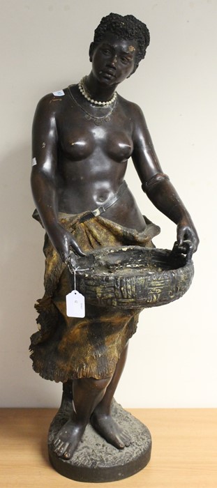 A large Goldscheider terracotta Blackamoor figure of a bare breasted nubile, standing holding a