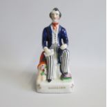 A Staffordshire Seated figure of Richard Cobden MP. Titled in gilt Date: circa 1840  Size: 8.5cm