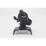 A Chinese bronze figure of Hotei, late Qing Dynasty, 19th Century, modelled standing and holding a