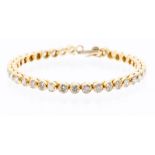 A diamond and 18ct yellow gold tennis bracelet, comprising alternate thirty-eight collet set