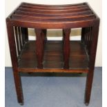 An early 19th Century mahogany five tier Canterbury, with shaped divider supports, raised on