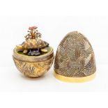 Stuart Devlin silver gilt surprise egg, textured cross hatch decorative form opening to reveal a