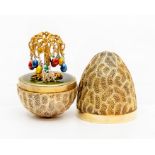 Stuart Devlin silver gilt surprise 'Easter egg tree' egg, decorative textured form opening to reveal