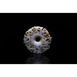 A Chinese carved jade archaistic style disc, Bi, probably Ming Dynasty, early to mid 17th Century,