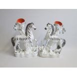 A pair of Staffordshire Zebra Spill Holders  Date circa 1860 Size: 18cm diameter, 29cm high