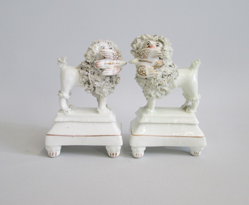 A Pair of Staffordshire ‘Lion Clipped’ Poodles  standing on footed oblong tiered plinths. Both