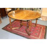 A Rupert Griffiths Arts and Crafts Monastic Woodcraft joined oak gateleg table, of circular form,