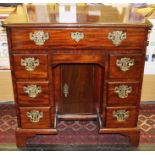A George II mahogany kneehole desk, circa 1750, fitted with a single drawer to top, a secret