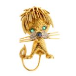 A vintage 18ct gold lion brooch, emerald set eyes with cabochon sapphire set nose, the cheeks pave