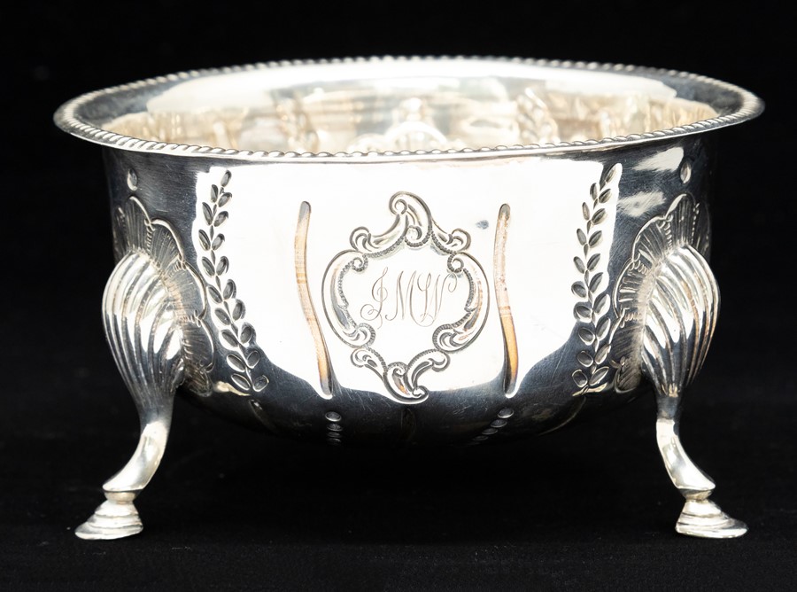 An Irish Georgian style circular sugar bowl, dart rim above body chased with wyvern fluting and